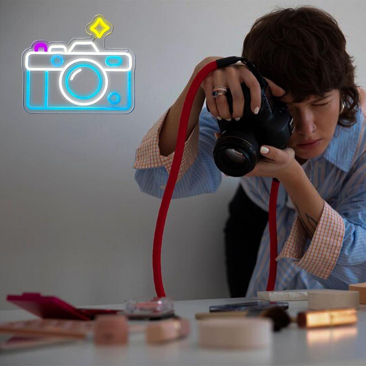 Camera neon sign in a photo studio